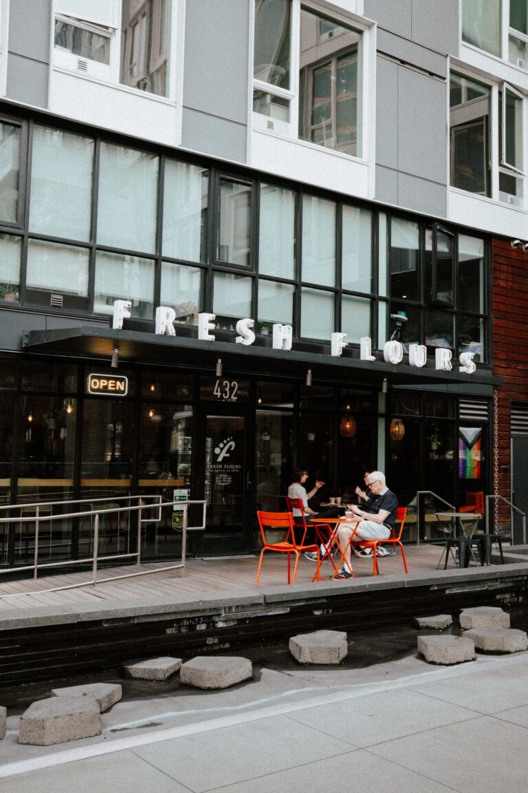 A lively street cafe scene in Seattle with outdoor seating area and customers enjoying their time.